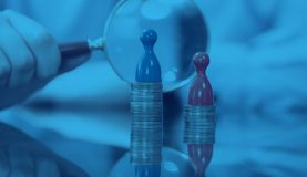 An image of playing pieces on 2 different stacks of coins with a magnifying glass in the background